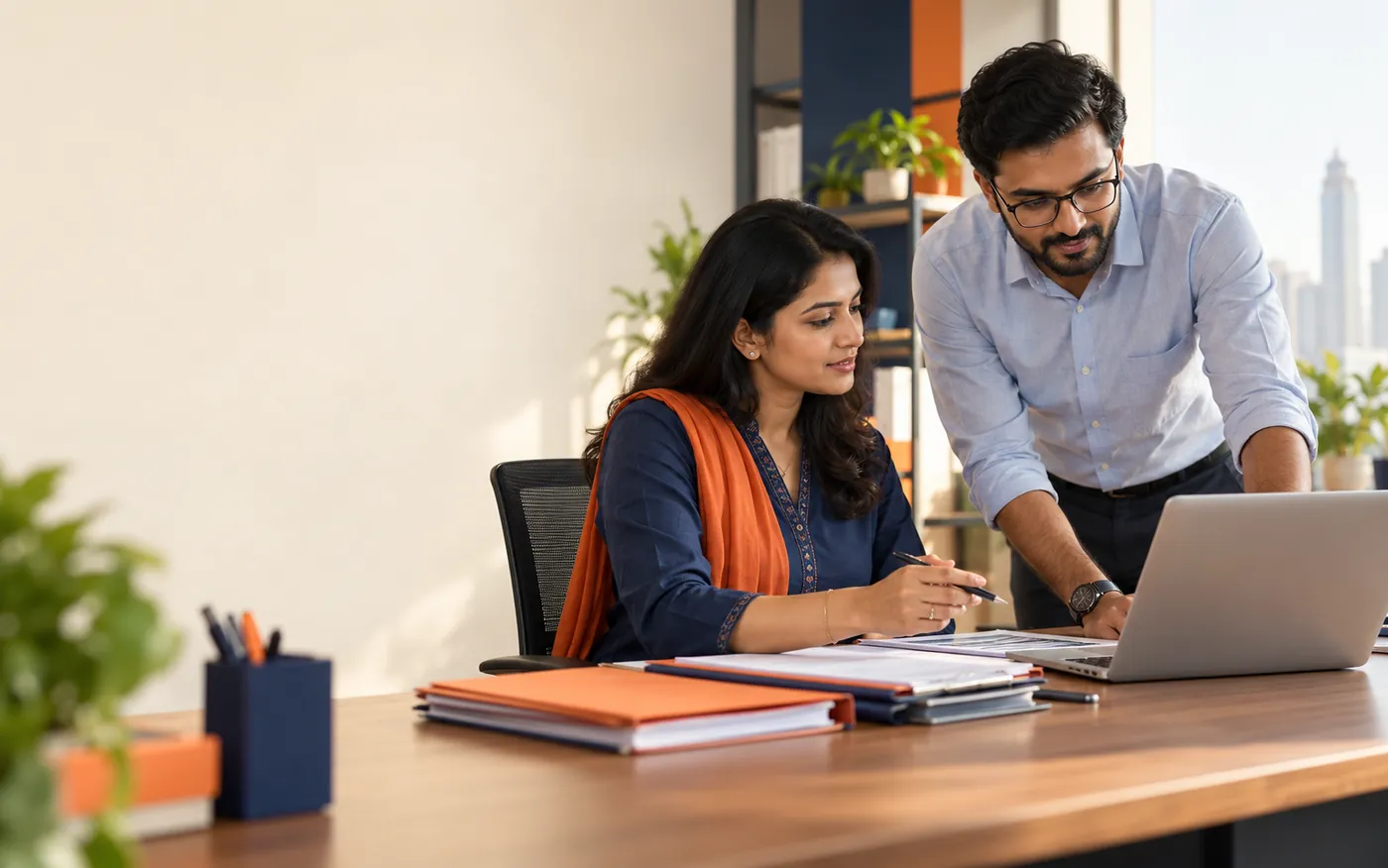 Illustrative office scene of HR and finance colleagues reviewing payroll