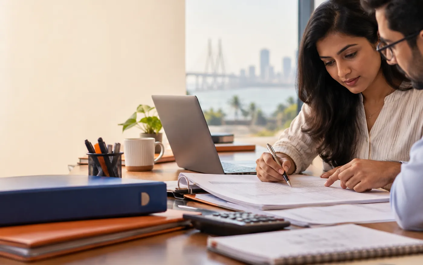 Illustrative payroll specialists reviewing monthly salary records in Mumbai